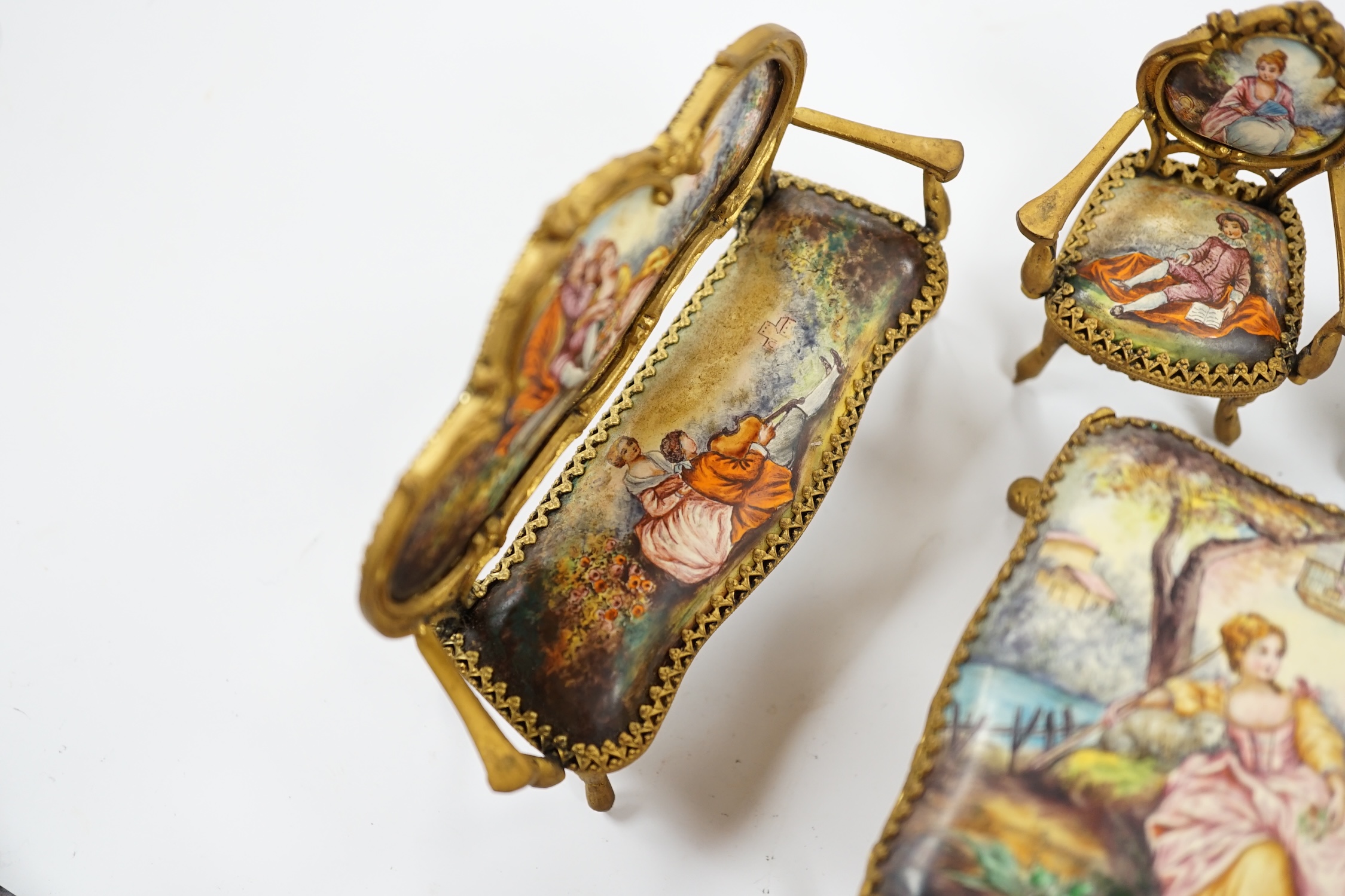 An early 20th century miniature enamel and gilt metal framed furniture set, possibly Austrian, largest 9cm wide. Condition - fair